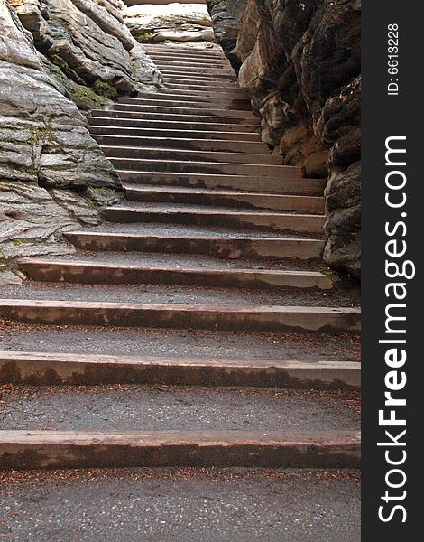 Detail of a stone staircase winding through a narrow canyon. Detail of a stone staircase winding through a narrow canyon