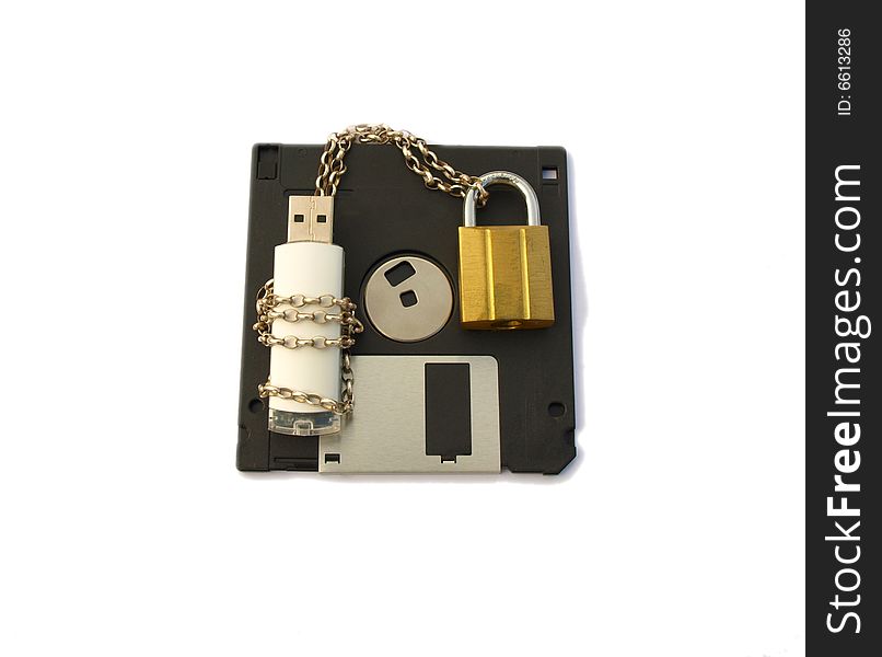 Photograph of a computer data stick, wrapped with silver chain and padlocked with gold padlock, lying on a floppy disk. Isolated white background. Photograph of a computer data stick, wrapped with silver chain and padlocked with gold padlock, lying on a floppy disk. Isolated white background.