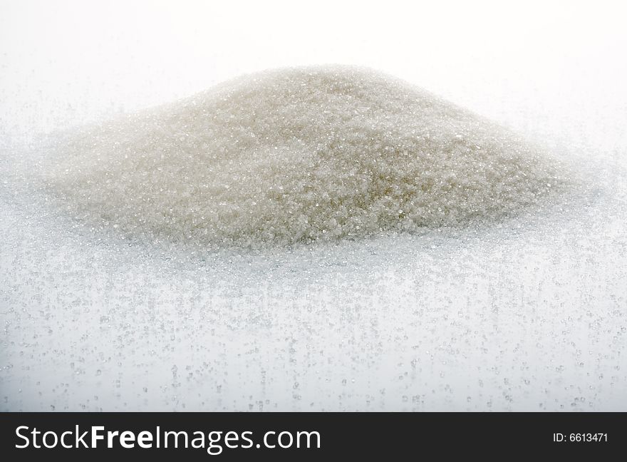 The big heap of sugar on a white background