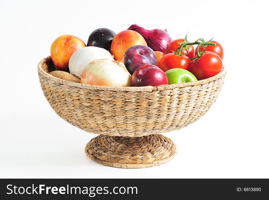 Pedestal basket full of autumn fruits and vegetables. Pedestal basket full of autumn fruits and vegetables