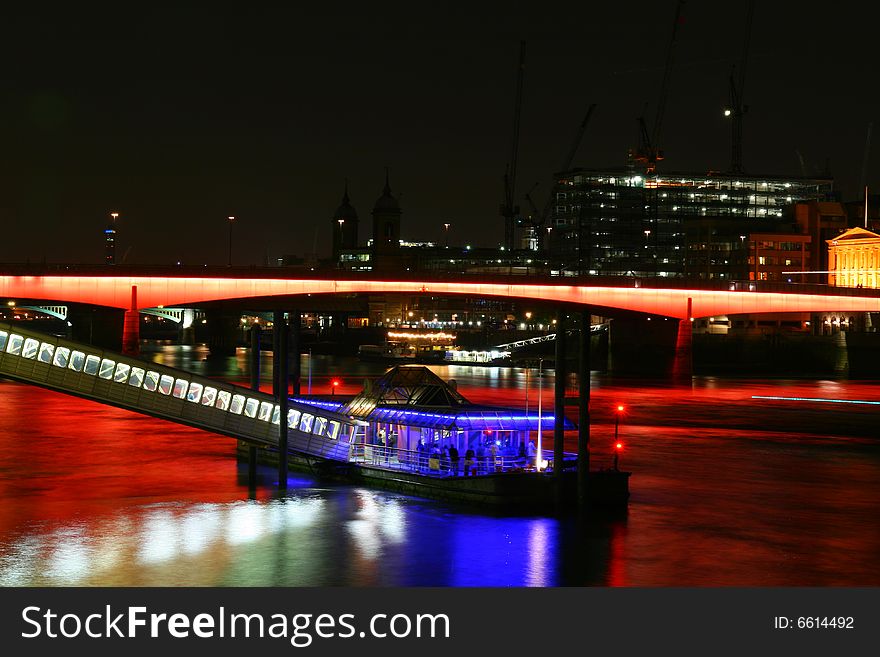 A colourful photo of London bridge at night