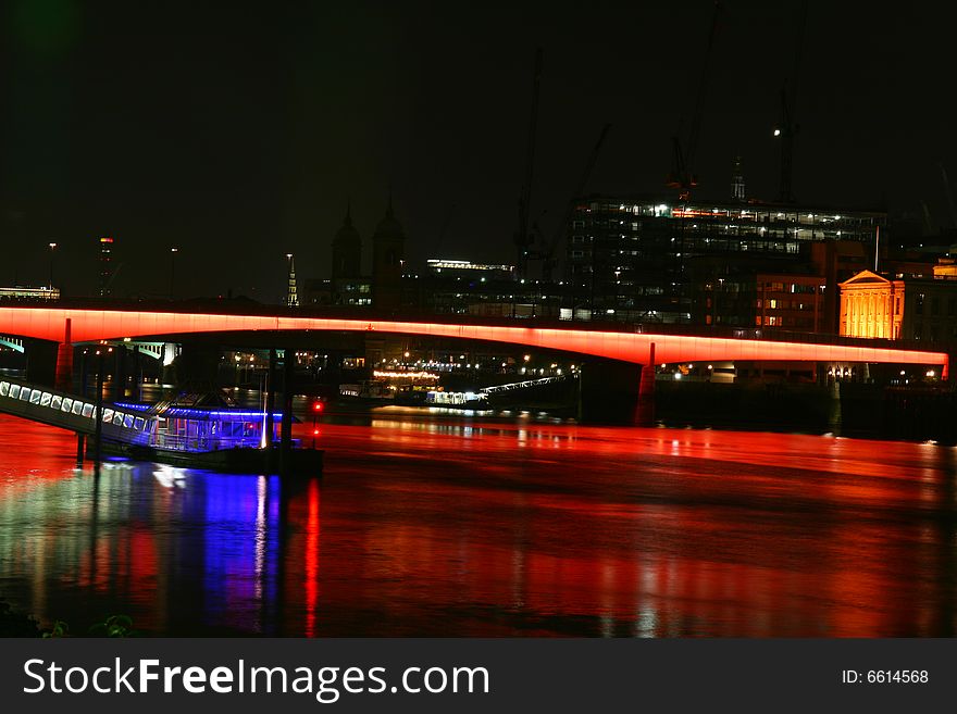 A colourful photo of London bridge at night