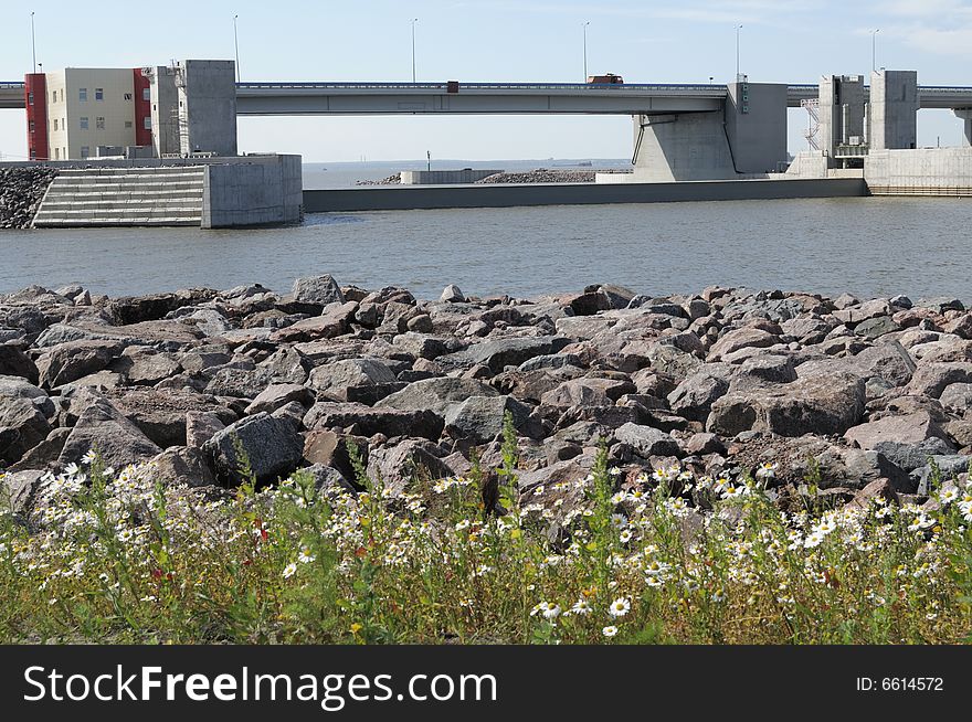 Site of a dam with the lifted valve interfering passage of water. Site of a dam with the lifted valve interfering passage of water.