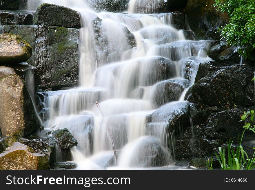 A water fall in a park at valley gardens in London UK. A water fall in a park at valley gardens in London UK