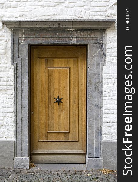 Old woodden Door with a marble marble.The marble frame has a inscription on the Latin. Old woodden Door with a marble marble.The marble frame has a inscription on the Latin.