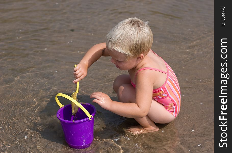 Girl playing in the sand. Girl playing in the sand