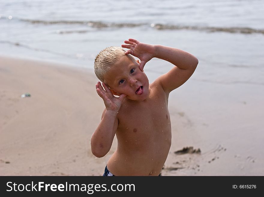 Boy goofing around at the beach. Boy goofing around at the beach