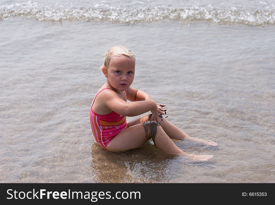 Girl Playing At The Beach