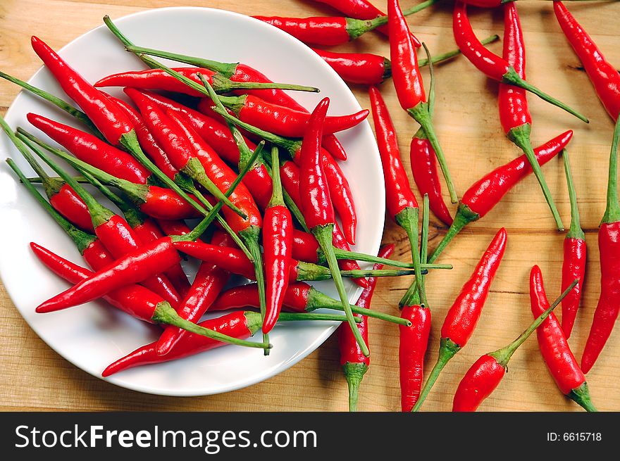 Red chili peppers on white plate