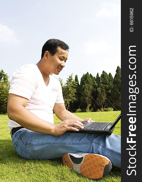 Man using a laptop outdoors