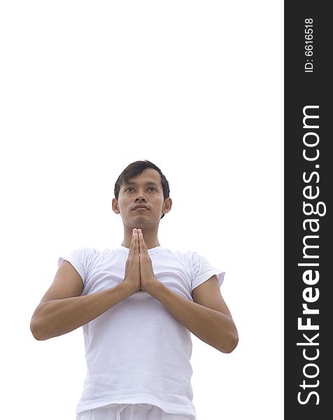A young man practicing yoga outdoors. A young man practicing yoga outdoors
