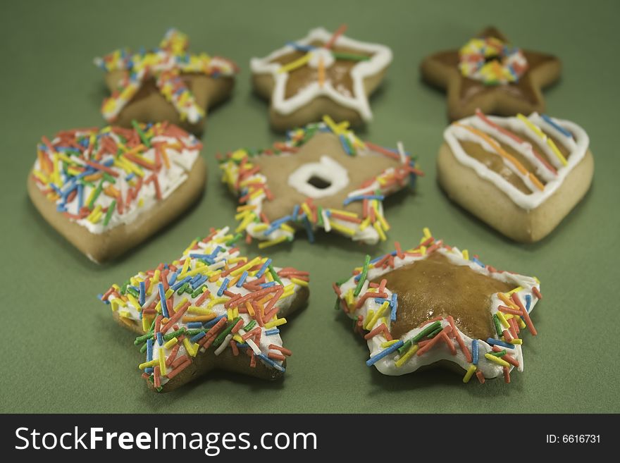 Decorated gingerbread cookies on green paper. Decorated gingerbread cookies on green paper