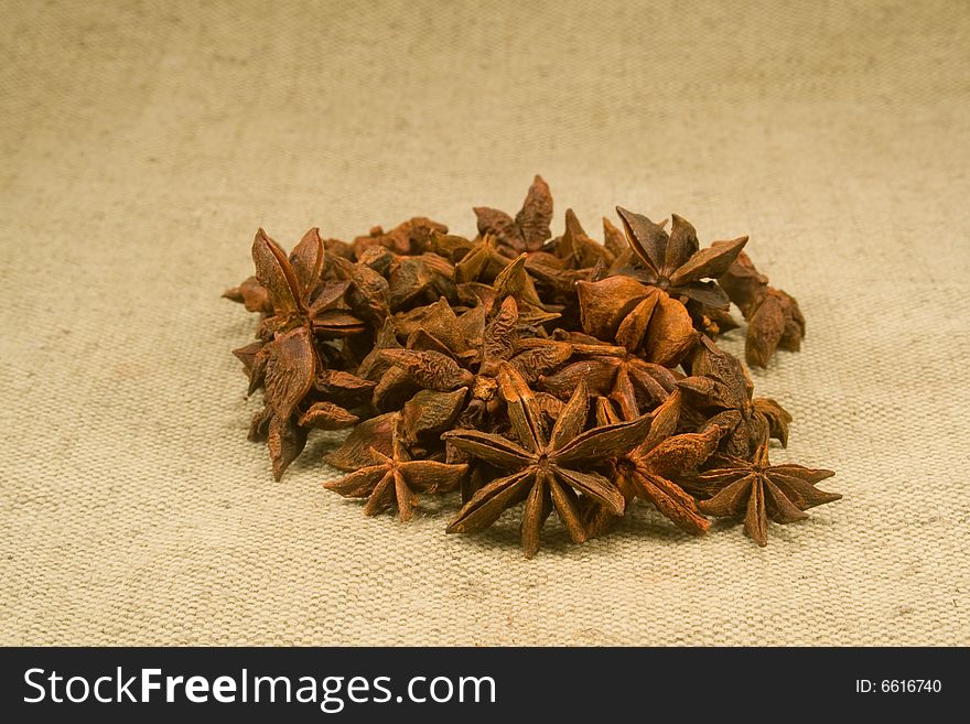Whole dried star anise fruits on burlap