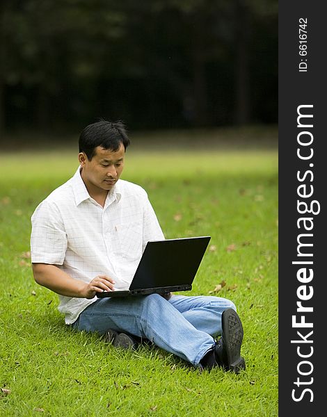 Man Using A Laptop Outdoors