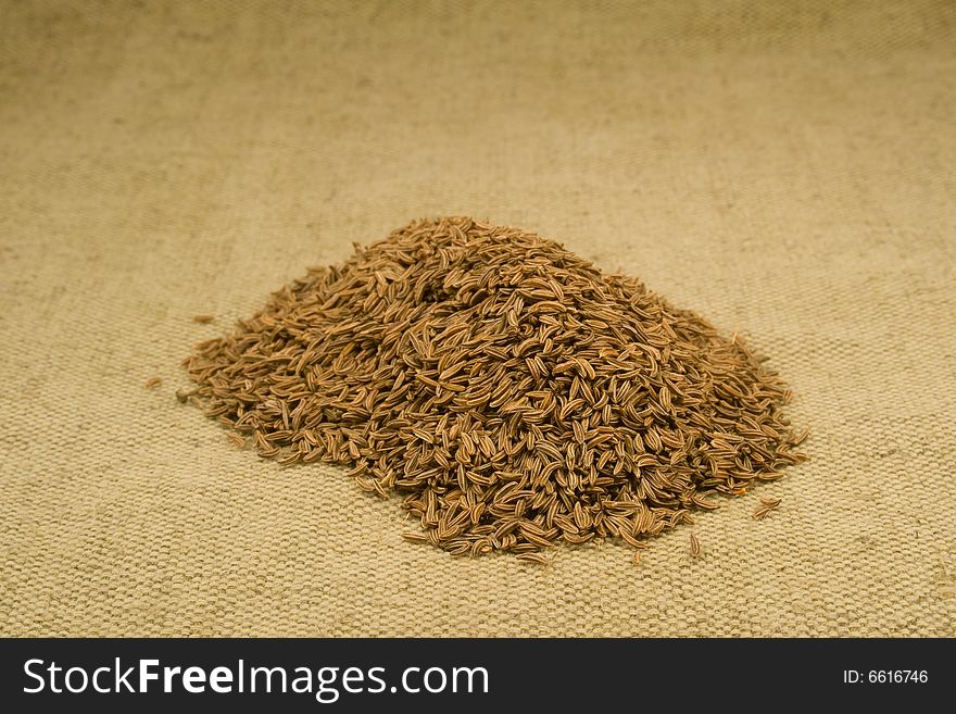 Whole dried cumin seeds on burlap