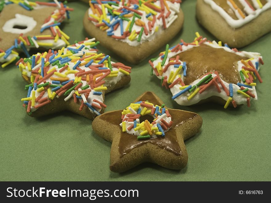 Decorated gingerbread cookies on green paper. Decorated gingerbread cookies on green paper