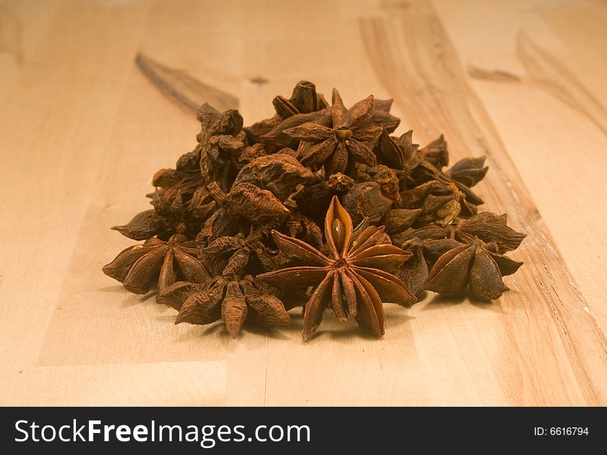 Whole dried star anise fruits on wood