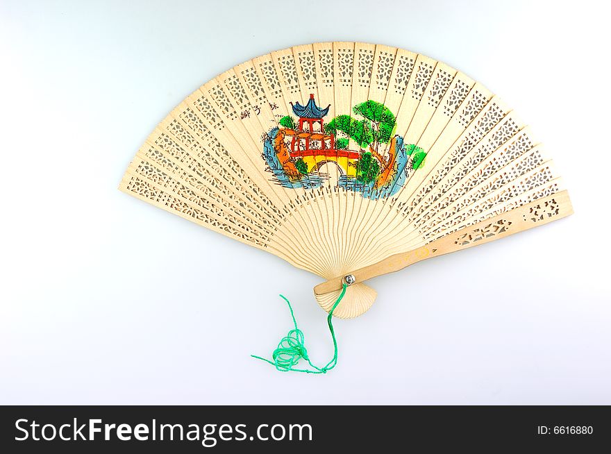 An expanding wooden folding fan on white background