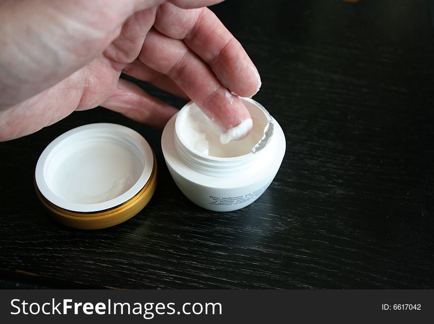Small bank with cream for leaving for skin of the hand