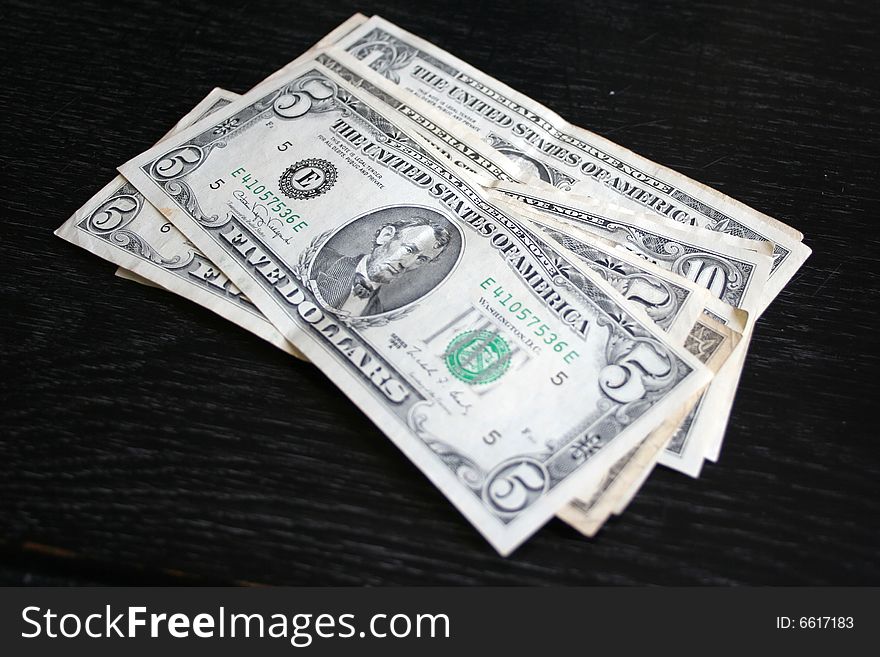Several old small dollars on dark background. Several old small dollars on dark background