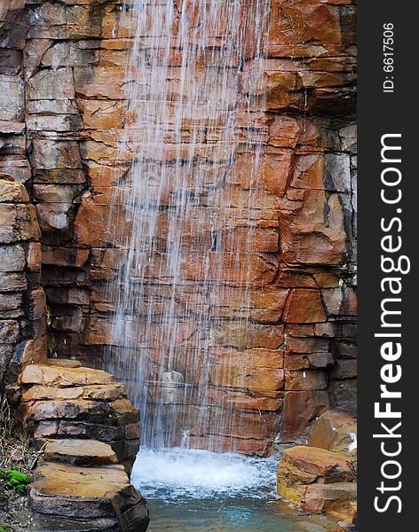 This is a shot of a man made waterfall at a local water park.