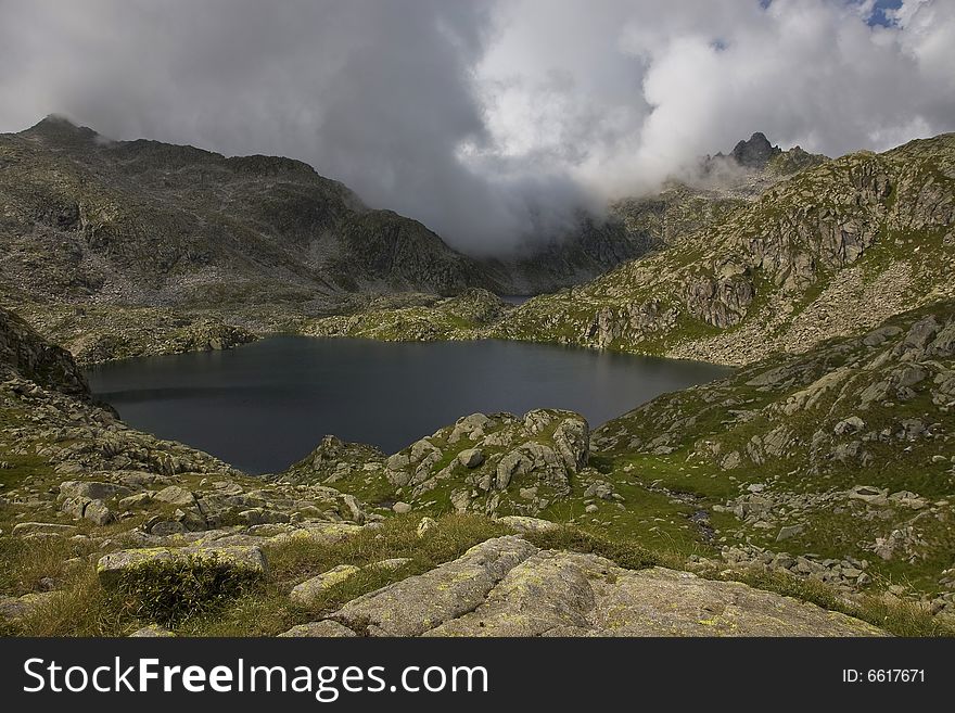 A small lake in Italien mountains, clouds were just approaching. A small lake in Italien mountains, clouds were just approaching