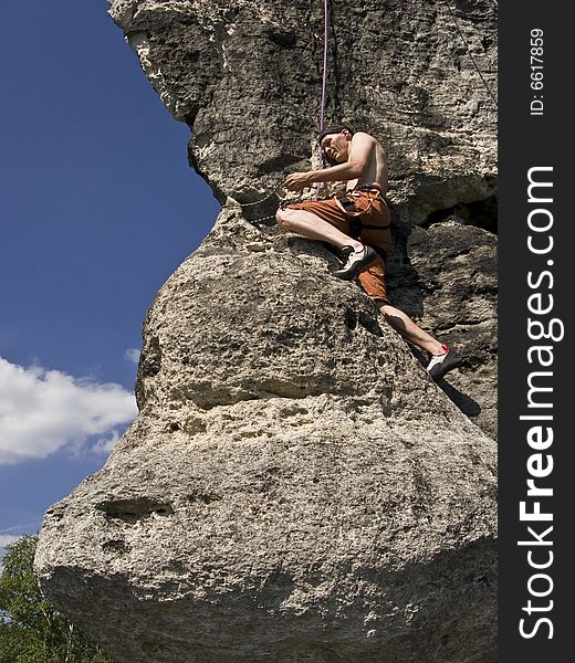 A man climbing at rocks in northern Bohemia, Czech republic