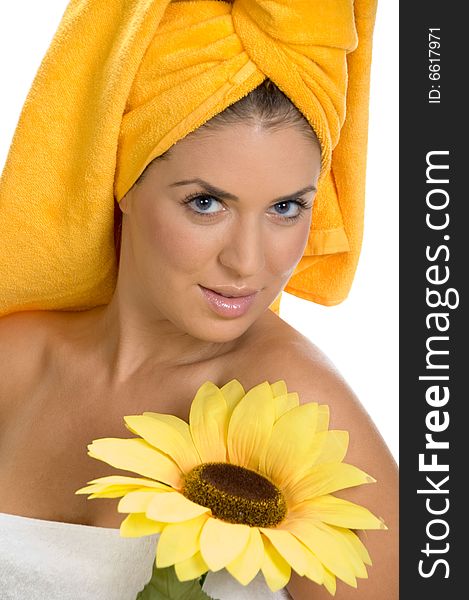 A posing smiling sexy female in towel with sunflower