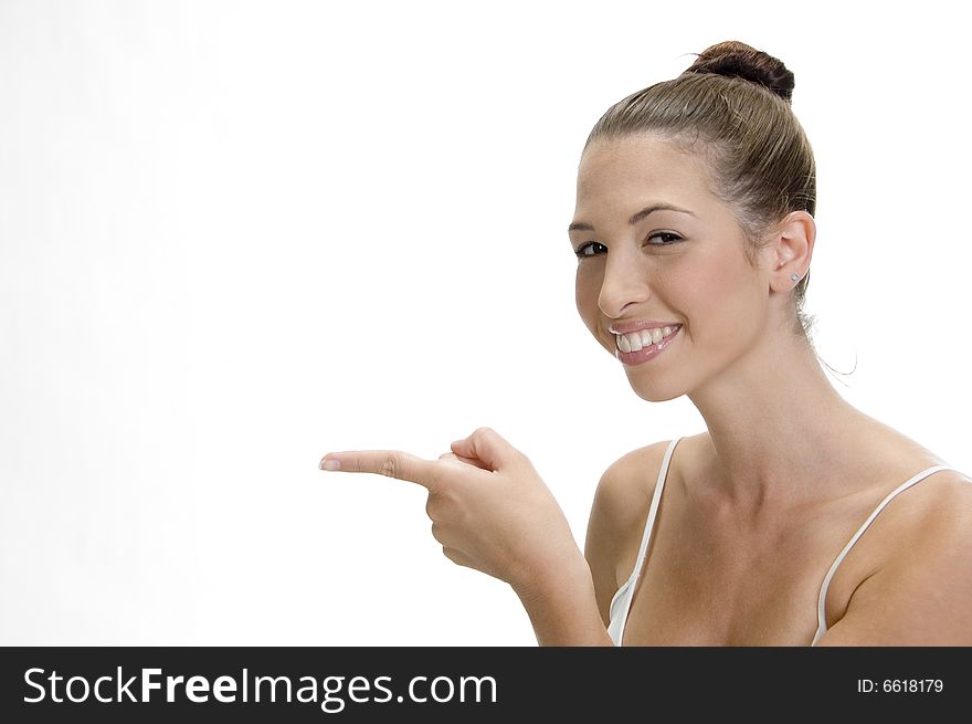 A happy young smiling woman pointing