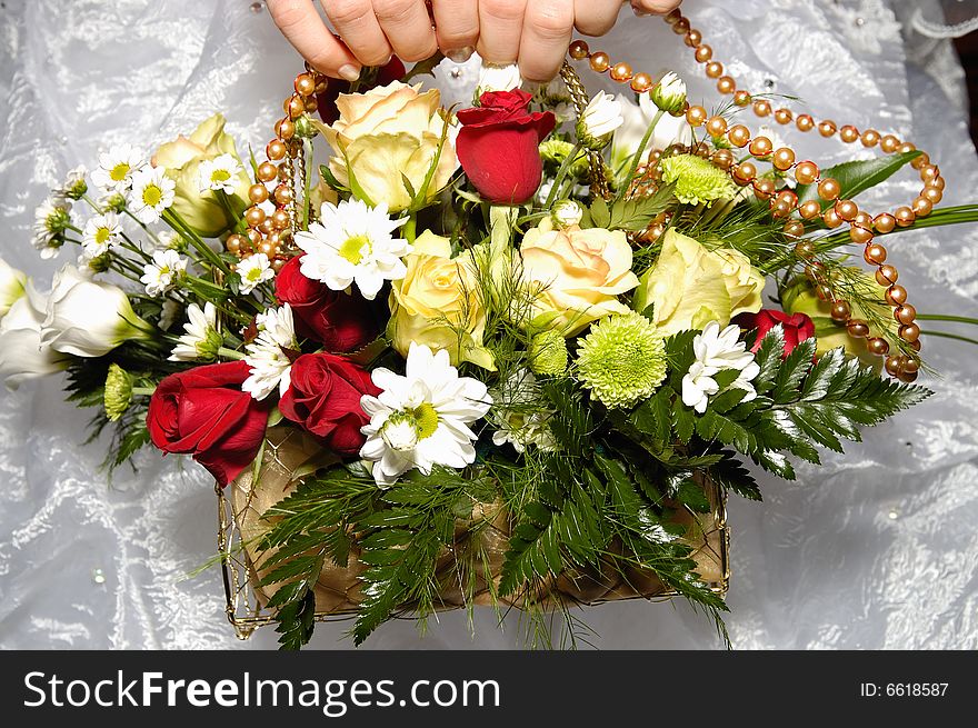 Bride's hands holding wedding bouquet. Bride's hands holding wedding bouquet
