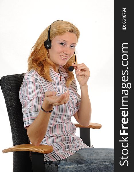 Young woman with headset, sitting in a office chair.Isolated over white. Young woman with headset, sitting in a office chair.Isolated over white.