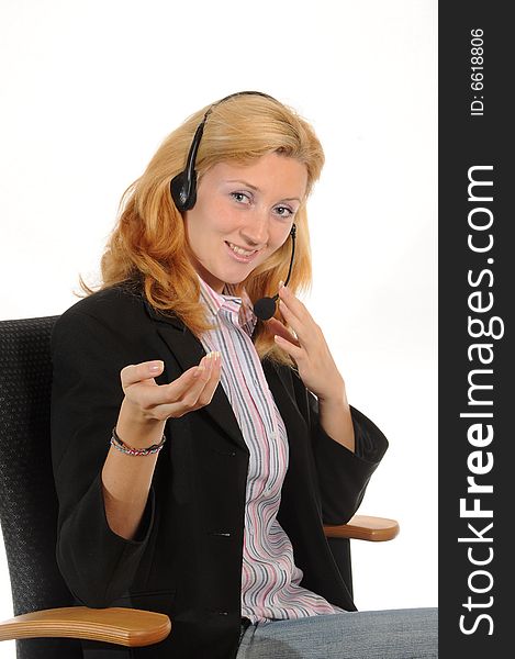 Young woman with headset, sitting in a office chair.Isolated over white. Young woman with headset, sitting in a office chair.Isolated over white.