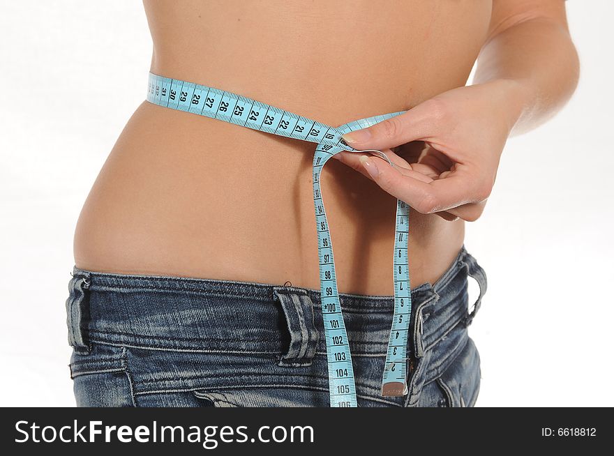 Young woman measuring her waist.Isolated over white. Young woman measuring her waist.Isolated over white.