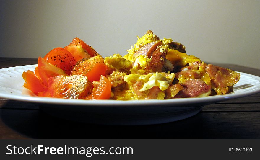 Scrambled eggs meal with tomatoes on plate. Scrambled eggs meal with tomatoes on plate.