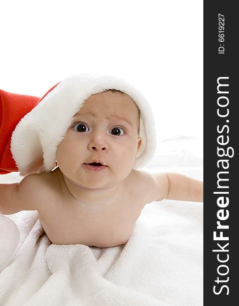 Cute baby lying with santa cap against white background