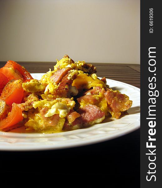 Scrambled eggs meal with tomatoes on plate. Scrambled eggs meal with tomatoes on plate.