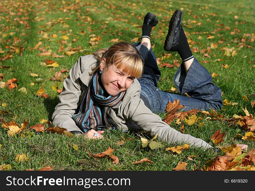Beautiful blond  young woman in autumn park. Beautiful blond  young woman in autumn park