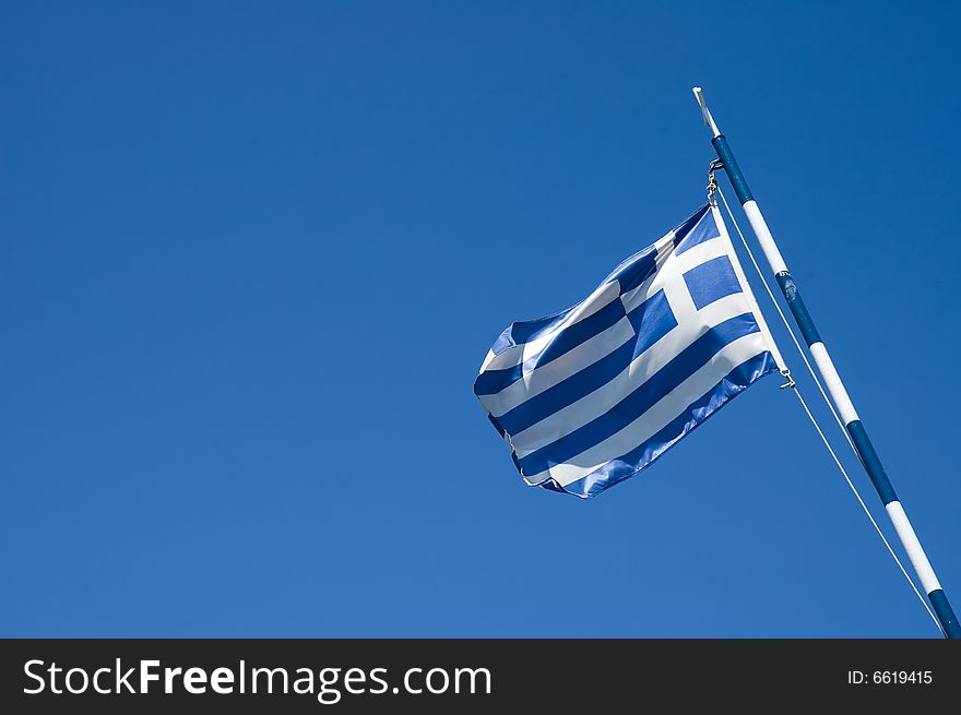 Photo of greece flag over blue sky