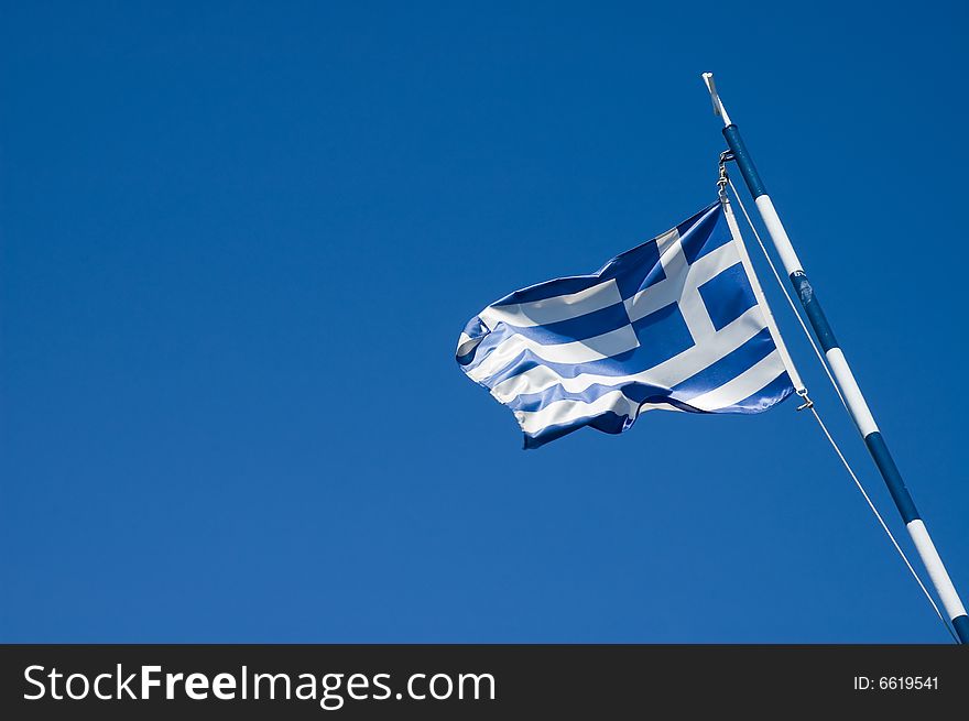 Photo of greece flag over blue sky