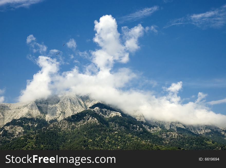 Photo of high mountain in clouds