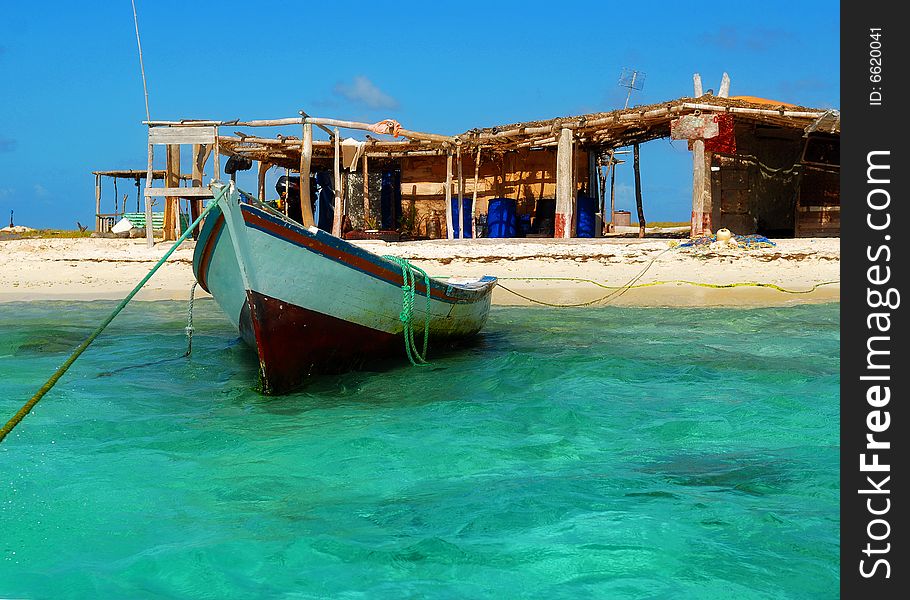 Boat of the fisherman and hut on island on Caribbean Islands. Boat of the fisherman and hut on island on Caribbean Islands