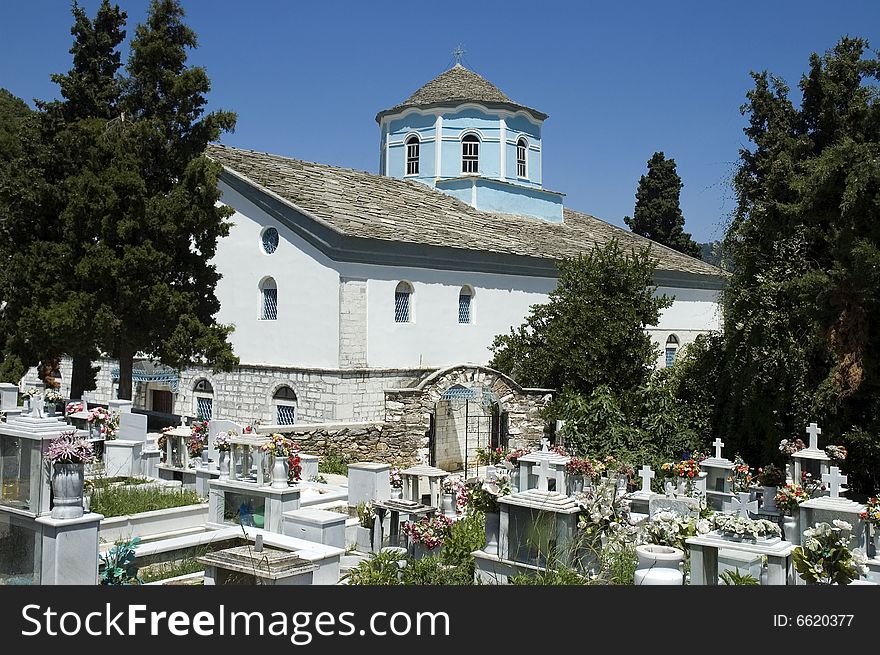 Photo of greece church with cemetery