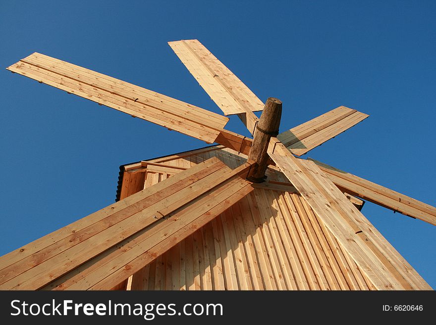 Rural wooden windmill against clear deep blue sky. Rural wooden windmill against clear deep blue sky