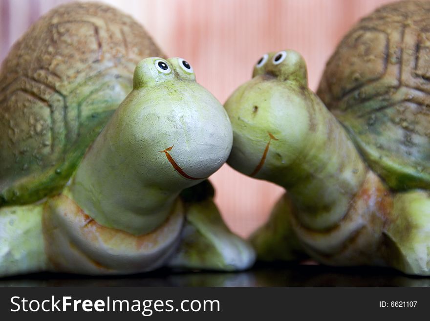 One turtle lovingly kisses the cheek of another turtle. One turtle lovingly kisses the cheek of another turtle.