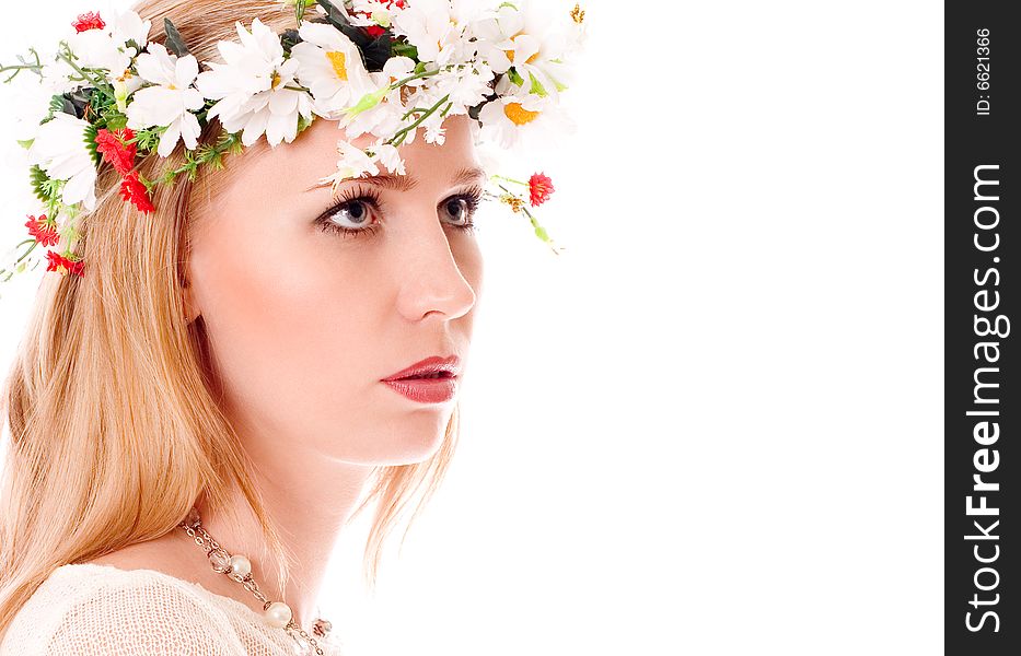 Pretty spring girl with wreath on head looking forward on white background