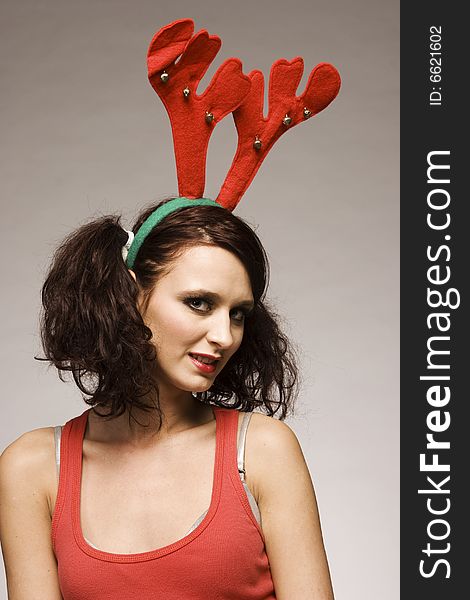 Beautiful brunette christmas reindeer girl with antlers. Beautiful brunette christmas reindeer girl with antlers