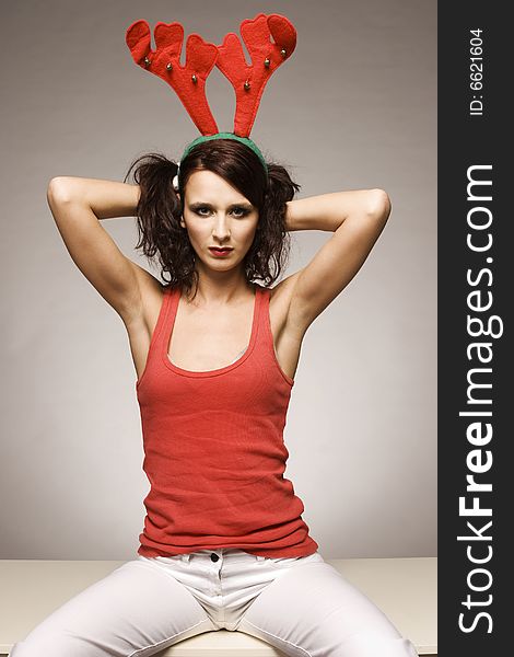 Beautiful brunette christmas reindeer girl with antlers. Beautiful brunette christmas reindeer girl with antlers