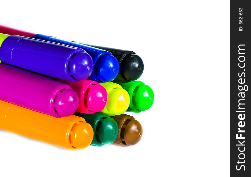 Varicoloured markers on the white isolated background