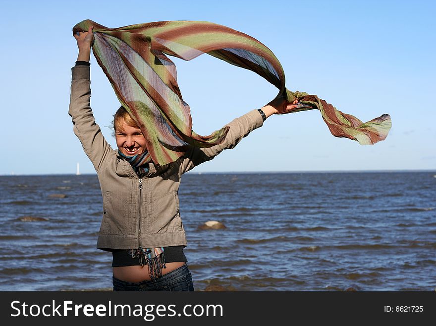 Blond woman with scarf. Windy day.