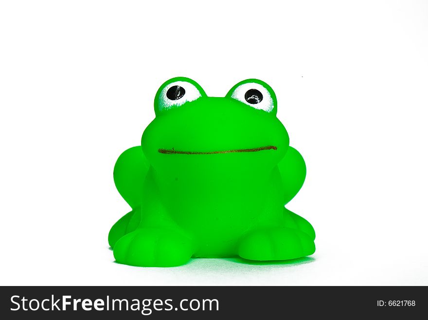 Green rubber toy frog for bathing on a white background